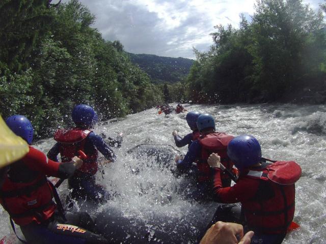Sporty people river rafting